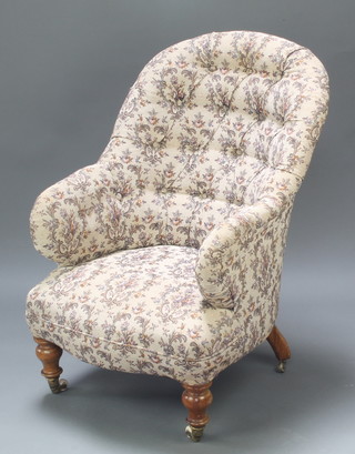 A Victorian tub back chair upholstered in tapestry material, raised on turned supports 