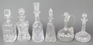 A waisted spirit decanter and stopper 11", 5 other decanters and a spare stopper