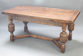 A 17th Century style carved oak refectory style draw leaf dining table with carved apron, raised on cup and cover supports with Y shaped stretcher 30"h x 33"w x  66" x 101"l  when extended 