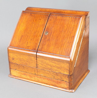 A Victorian wedge shaped oak stationery box with stepped interior, fitted a perpetual calendar and a secret drawer 14"h x 16"w x 10"d 