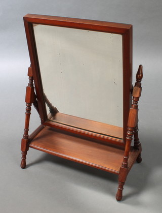 A Victorian aesthetic movement rectangular plate dressing table mirror contained in a mahogany swing frame 27 1/2"h x 20"w x 11" 