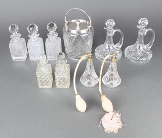 A silver plated mounted cut glass biscuit barrel, a pair of ewers, 2 atomisers and 5 toilet bottles 