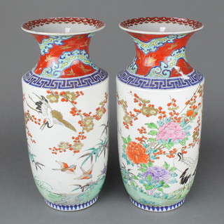 A pair of 20th Century Japanese vases decorated with exotic birds 15", having a painted 6 character mark to the vase 