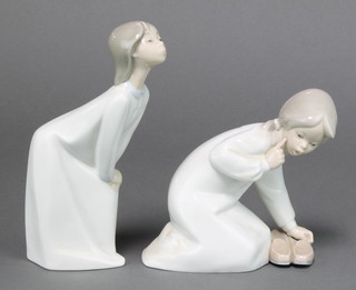 A Lladro figure of a child wearing a night dress 7 1/2", a ditto of a child with slippers 5" 