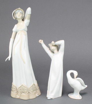 A Lladro figure of a yawning boy 8 1/2", a ditto of a goose 4 1/2" and a Spanish figure of a lady 13 1/2" 