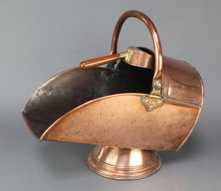 A Victorian copper helmet shaped coal scuttle complete with shovel 