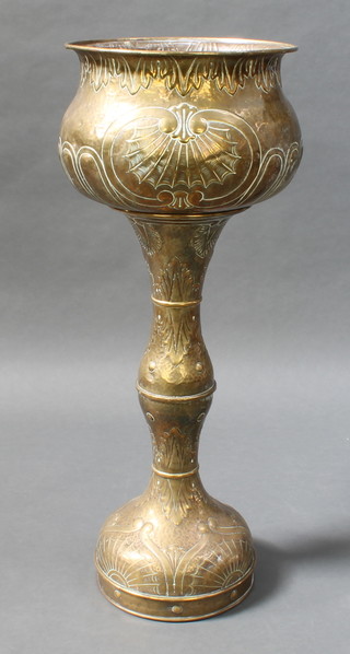 An Art Nouveau  circular embossed brass jardiniere raised on a column 41"h x 15 1/2" diam. 
