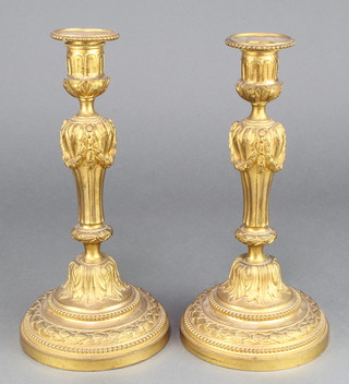 A pair of 19th Century gilt ormolu candlesticks with detachable sconces and fluted bodies 10" (slightly bent) 