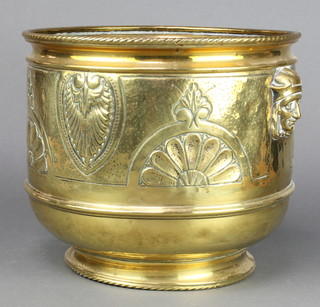 A circular Art Nouveau embossed brass jardiniere with mask decoration 10 1/2" x 11 1/2" 