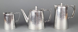 An Old Hall polished  planished pewter teapot, matching hot water jug and cream jug 
