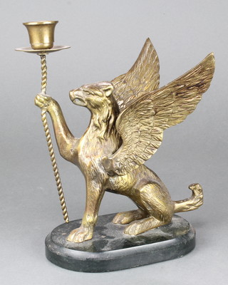 A bronze candlestick supported by a griffin 8"h 
