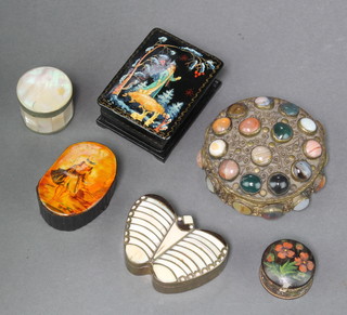 A Victorian shaped black lacquered box decorated a paddling girl 1"h x 2"w x 1 1/2", a Russian black lacquered box decorated a figure raised on bracket feet 1" x 2" x 3" (hinge to lid f), a white metal jar and cover decorated cabochon cut stones 1" x 3" diam. and 3 other other boxes