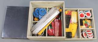 A shallow box containing various red and green Meccano and a ring binder containing photocopies of Systems newsletters 