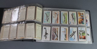 A loose leaf album of cigarette cards - John Players, Wills, Murray & Sons 