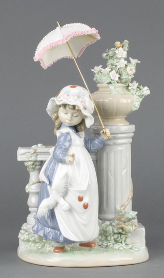 A Lladro group of a child standing beside a column and a urn of flowers, holding an umbrella 12" 