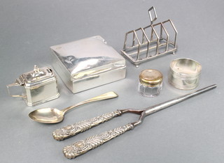 A Victorian silver toast rack Sheffield 1894, a rectangular mustard Birmingham 1928, a napkin ring and silver cigarette box, weighable silver 130 grams 