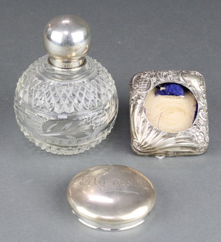A silver topped cut glass scent bottle London 1924 4 1/2", a silver lid and a silver frame 
