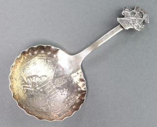 A Dutch silver caddy spoon, the bowl decorated with figures in a country garden, import marks London 1900, 20 grams 