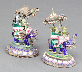 A pair of Indian silver and enamelled groups of an elephant, rider and passenger on raised oval bases 3" 