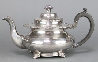 A victorian silver plated squat bulbous teapot with scroll and floral decoration and ebony handle 
