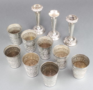 A set of 8 silver plated beakers and 3 spill vases 