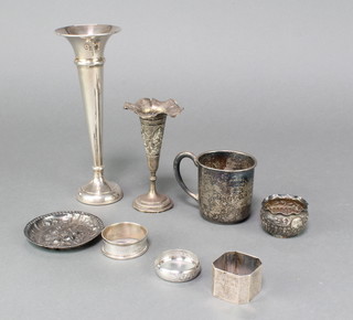A sterling silver mug, a nut dish (chipped), 3 napkin rings and 2 spill vases, a silver salt, weighable silver 220 grams 