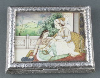 An early 20th century Indian silver rectangular cigarette box with painted ivory panelled lid depicting a couple sitting on a terrace the box is decorated with flowers 3 3/4" x 3", 142 grams 