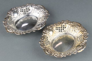 A pair of repousse pierced silver bon bon dishes with floral and scroll decoration London 1971, 6", 168 grams  