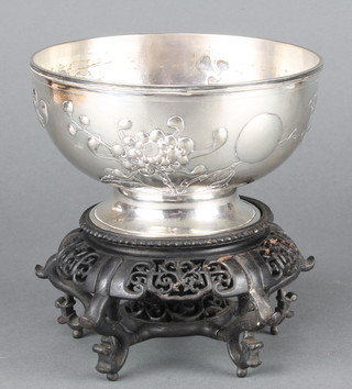 An early 20th Century Chinese repousse silver bowl decorated with peony, maker Tuck Chang 6", 11 ozs raised on a carved hardwood stand
