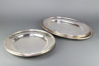 A set of silver plated fish servers comprising a pair of circular servers 15 1/2", 3 oval ensuite ditto 19 1/2" and a large oval ditto 21 1/2" 