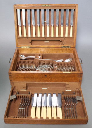 An Edwardian oak canteen containing a set of plated cutlery for 12 