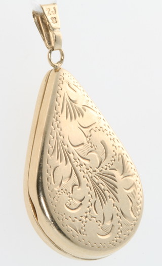 A 9ct pear shaped yellow gold locket with chased decoration, gross 4.5 grams