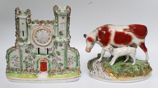 A Staffordshire group of a cow and a calf 10", ditto spill vase of castle form 10"