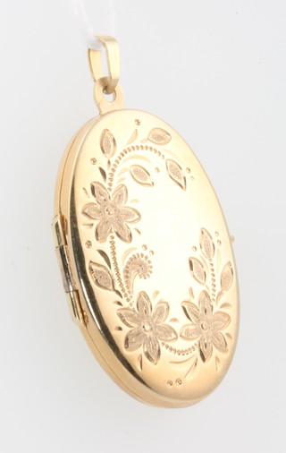 A 9ct oval locket with floral decoration 