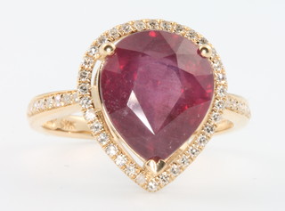A 14ct yellow gold pear shaped ruby and diamond cluster ring, the centre stone approx. 5.8ct surrounded by brilliant cut diamonds approx 0.4ct size M 1/2