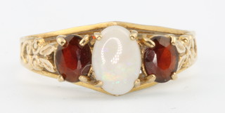 A 9ct yellow gold opal and garnet ring size M 1/2