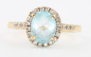 An 18ct yellow gold oval cut topaz and diamond ring, size Q