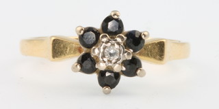 An 18ct yellow gold sapphire and diamond cluster ring size M 1/2