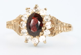 A 9ct yellow gold garnet and paste set ring size O 1/2