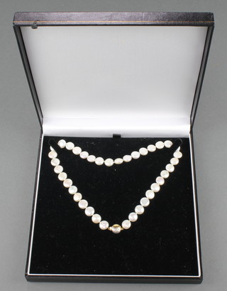 A modern cultured pearl necklace with an 18ct diamond set 2 colour gold clasp 