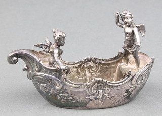 A Continental repousse silver model of a boat with 2 cherubs, import marks London 1897, 44 grams 