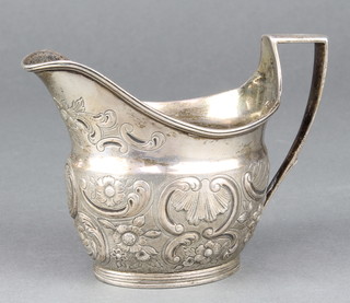 A George III repousse silver cream jug with scrolls and flowers London 1801, 152 grams 