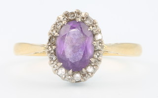 An 18ct yellow gold amethyst and diamond cluster ring size R 