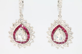 A pair of 18ct white gold pear shaped ruby and diamond earrings the centre stones approx. 0.68ct surrounded by diamonds approx. 1.48ct and rubies approx 1.55ct 