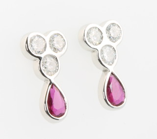 A pair of 18ct white gold ruby and diamond drop earrings, the pear shaped rubies approx. 0.83ct the brilliant cut diamonds approx 0.99ct 