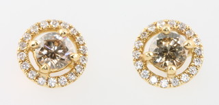 A pair of 18ct yellow gold diamond ear studs, the centre stones each approx 0.20 and 0.22ct, surrounded by brilliant cut diamonds approx. 0.12ct 