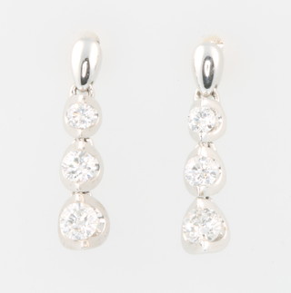 A pair of 15ct white gold diamond drop earrings