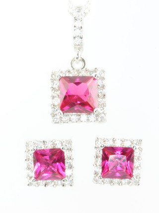 A pink cubic zirconia pendant and chain and a pair of ditto ear studs