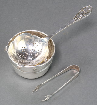 A silver tea strainer and stand Sheffield 1965 together with a pair of nips, 100 grams