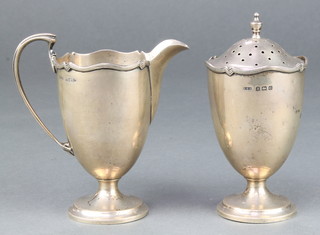 A silver cream jug and sugar shaker of classical form with wavy rim decoration Birmingham 1913, 181 grams 